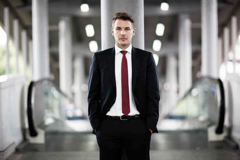 A casual corporate headshot of solicitor Daniel at the airport in central London.